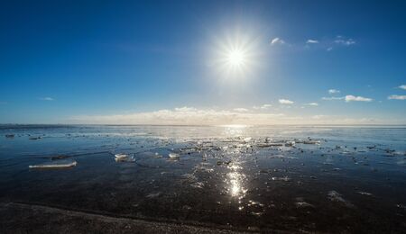 Frozen lake with the sun and flare effects, Beautiful landscape in winterの写真素材