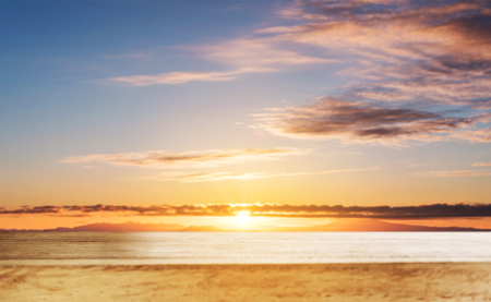 Wooden table top, with blur defocused sky in sunrise backgroundsの写真素材