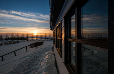 Rural house exterior with sunrise in winterの写真素材