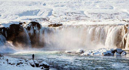 traveler standing at Godafoss water fall in winterの写真素材