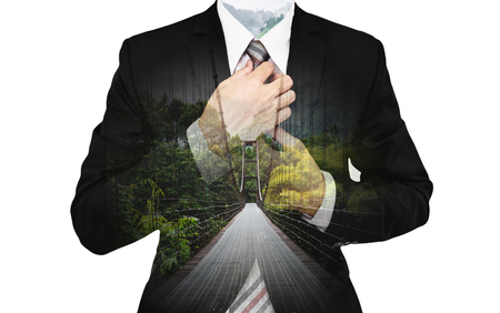 Double Exposure Businessman with suspension bridge and green forestの写真素材