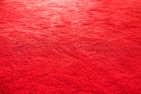 Red carpet texture with bright light, selective focusの写真素材