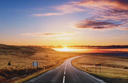 Picturesque country road landscaped, in summer sunriseの写真素材