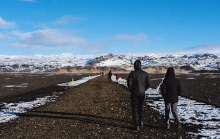 Couple walking on the road in winterの写真素材
