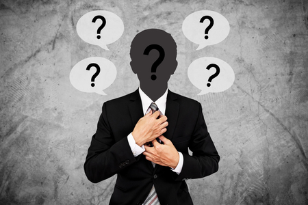 Businessman with question marks on head and blank text bubbles. for copy spaceの写真素材