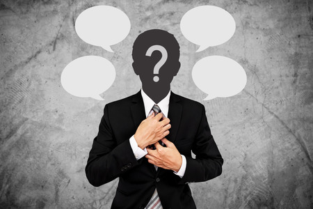Businessman with question marks on head and blank text bubbles. for copy spaceの写真素材