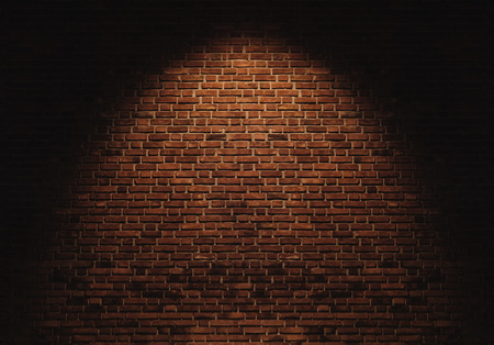 Bricks wall with light spot on center backgroundsの写真素材