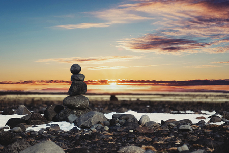 Balance stones, Zen stone stacked, with blurred sunset backgroundの写真素材