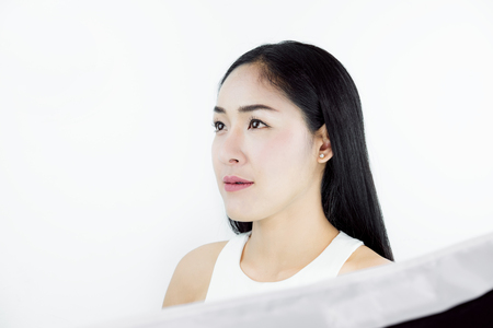 Studio Shot, Beautiful Asian Woman with Black Hair, with Healthy Skin, on white backgroundの写真素材
