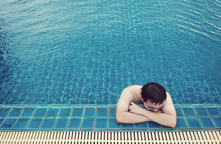 a guy relaxing in swimming in summerの写真素材