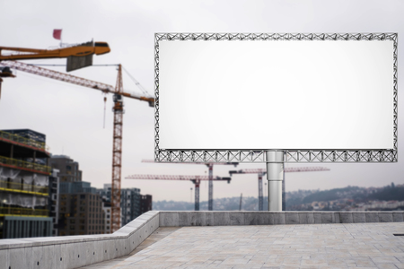 Blank billboard for advertisement at in the city with construction craneの写真素材