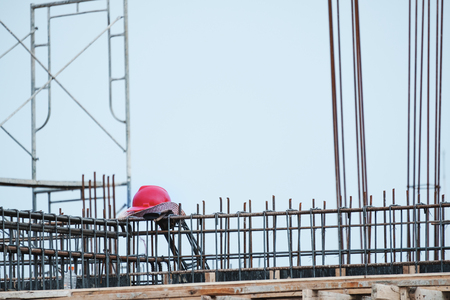 Construction site, Safety helmet on steel construction after workの写真素材