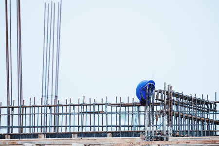 Construction site, Safety helmet on steel construction after work, safety firstの写真素材