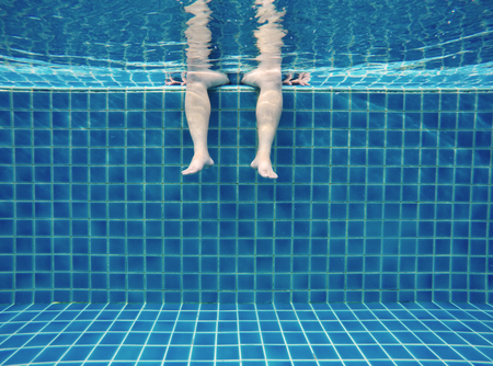 Relax underwater in swimming pool, summertime
