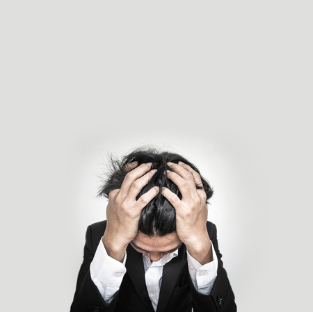 Stressed Young Businessman, on white backgroundの写真素材