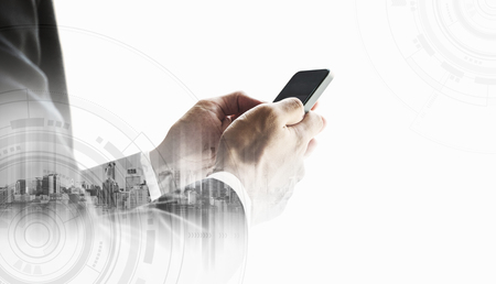 Businessman using smartphone with city,  on white background business communication technologyの写真素材