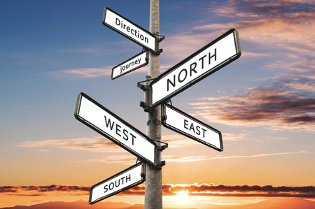 Directional signpost, with summer sky in sunset backgroundの写真素材