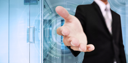 Businessman stretch out hand, with digital interface technology, with interior modern office backgroundの写真素材