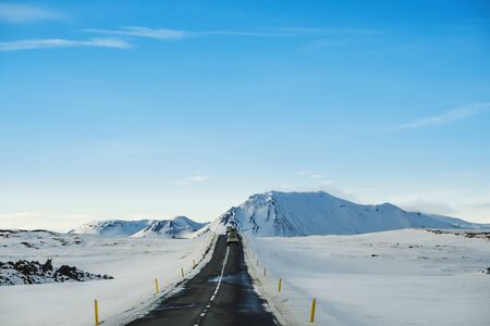 Landscaped the road in winter, with a cars driving on highway in Icelandの写真素材