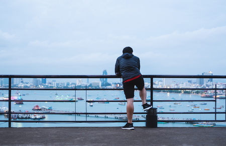 a man enjoying looking at Pattaya city view, after running in eveningの写真素材