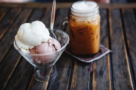 Summer Dessert, Iced Coffee with Ice Creams on wooden table, selective focus on Ice Cream Cupの写真素材