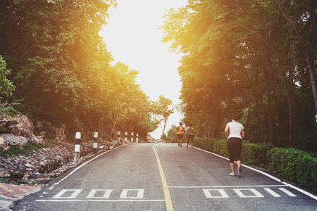 People running on the road in public parks under sunset at starting pointの写真素材
