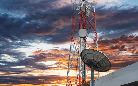 Telecommunication tower with Satellite dish, under sunset skyの写真素材
