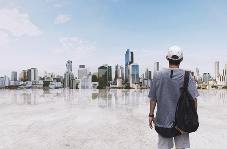 a man with backpack standing at sightseeing city view in the morningの写真素材