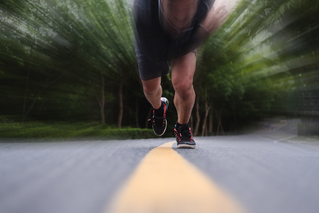 Runner running on the road, selective focus on shoes, with speed motionの写真素材