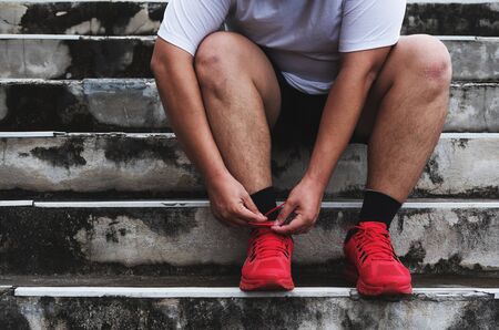 Asian Guy Tying Running Shoe, Preparing to Runningの写真素材