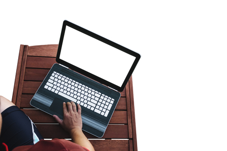 a man using computer lap top on wooden table, white empty computer screen, isolated on white background. Clipping path includedの写真素材