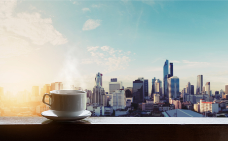 Morning hot coffee in sunrise, city backgroundsの写真素材