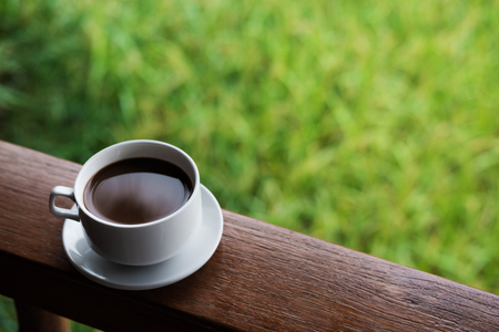 Hot Coffee cup on saucer, on wood panelの写真素材