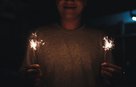 hands holding sparklers fireworkの写真素材