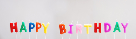Colorful Happy Birthday Candles on white backgroundの写真素材