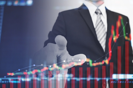 Double exposure businessman pointing to screen with raising graph, Business growth and investmentの写真素材