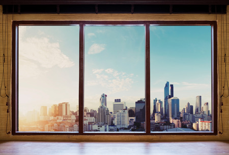 Looking through window in the morning, Bangkok city view in sunriseの写真素材
