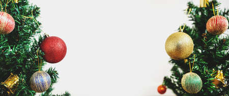 Christmas decoration background. Panoramic Christmas tree with colorful decorations, on white background with copy spaceの写真素材