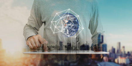 Businessman working on digital tablet with global network connection technology, city sunrise background. Element of this image are furnished by NASAの写真素材