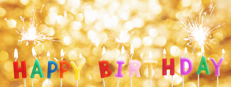 Happy Birthday Candles on Golden Bokeh light background with sparklerの写真素材