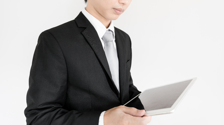 Businessman using digital tablet, on whiteの写真素材