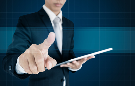 Businessman pressing on virtual screen, with copy spaceの写真素材
