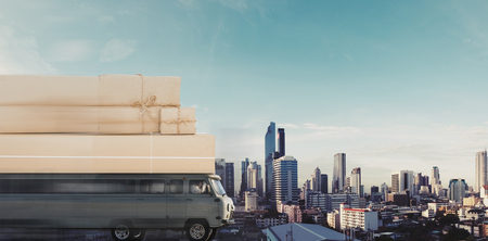 Delivery van with parcel boxes on roof driving fastの写真素材