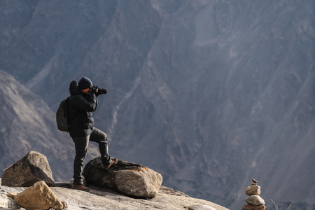 Photographer taking photo outdoor by dslr camera. Travel lifestyle