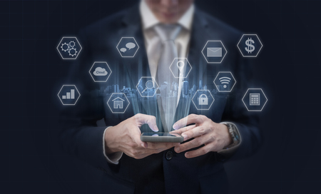 Businessman using mobile smart phone and application icons. Mobile application, social media and e-commerce technologyの写真素材