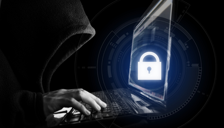Internet network security system. Hacker in black hoodie using computer laptop and technology lock  iconの写真素材