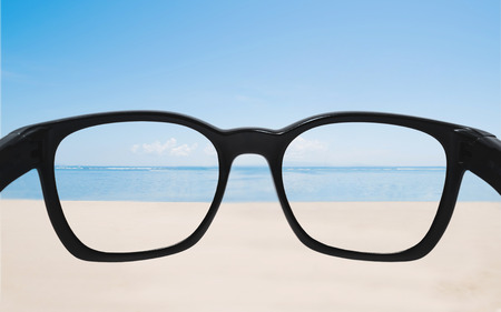 Summer holiday and vacation. Looking through sunglasses lens to beautiful beach in summerの写真素材