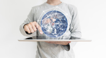a man working on digital tablet and global network connection hologram technology.の写真素材