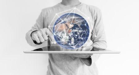 a man using digital tablet and global network connection hologram technology.の写真素材