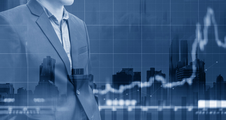 Double exposure, Businessman and raising graph diagram with city background. Business growth and investmentの写真素材